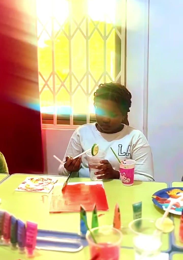A learner painting in art class