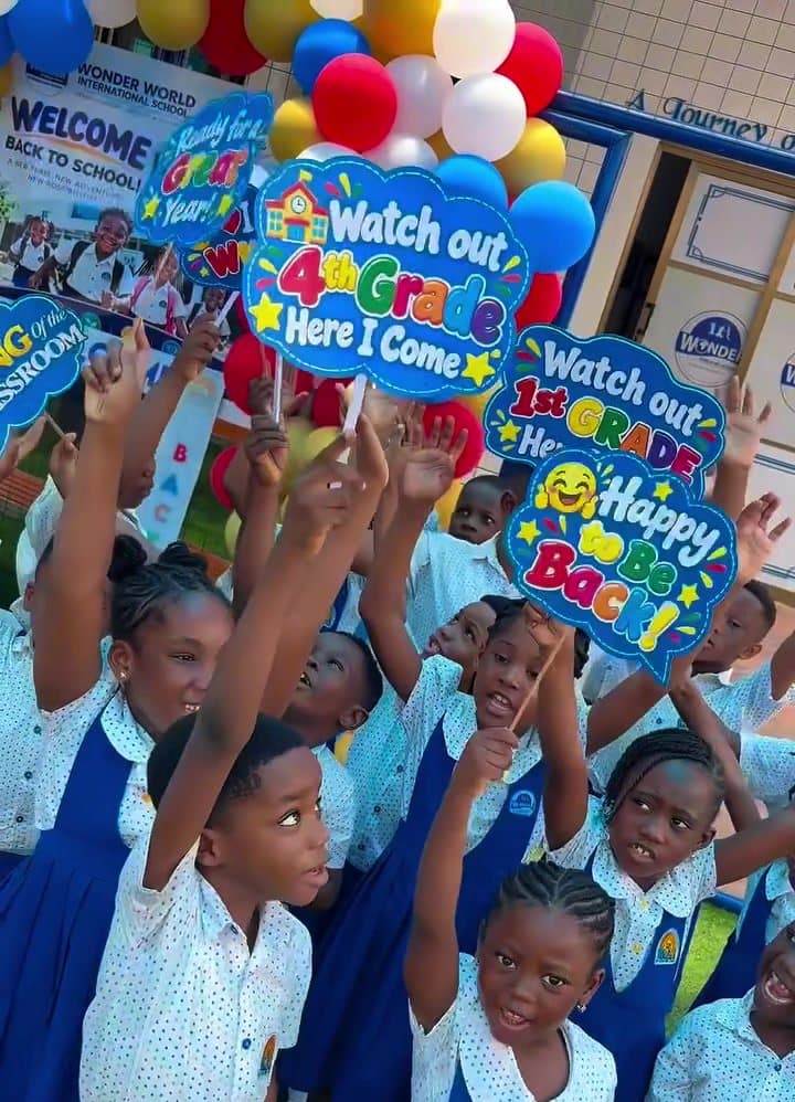 Learners holding ‘Happy to be back’ signs on the first day of school
