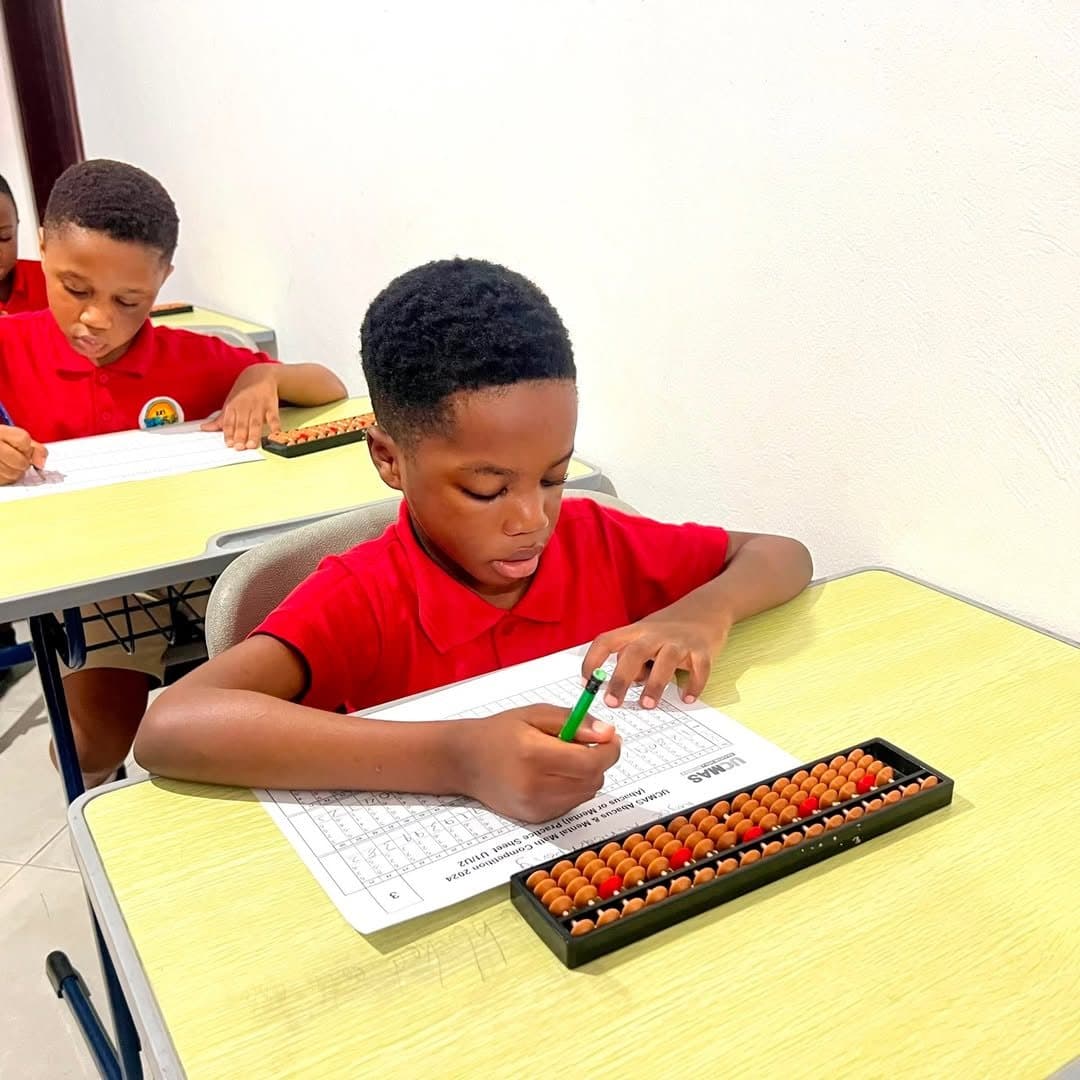 Primary learner working with an abacus